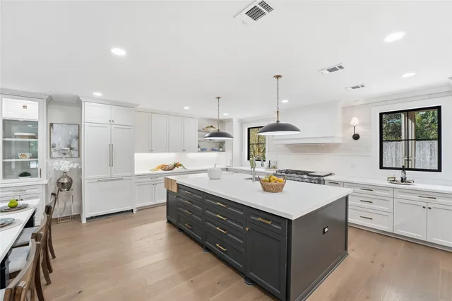 a kitchen with a stove a sink and a refrigerator
