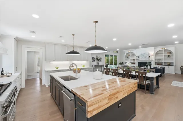 a large kitchen with kitchen island a sink table and chairs