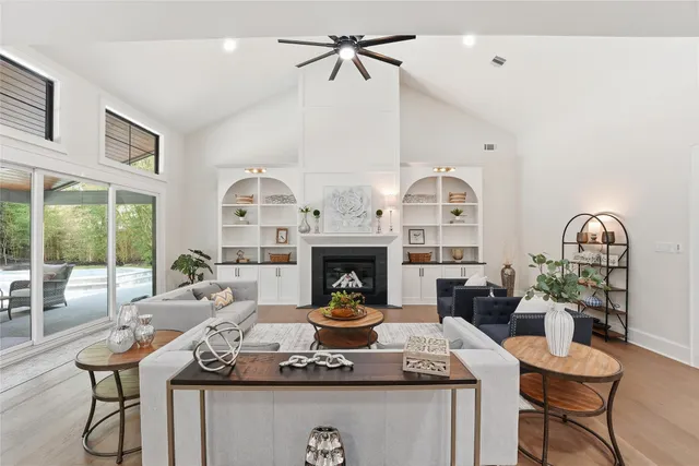 a living room with furniture a fireplace and a chandelier
