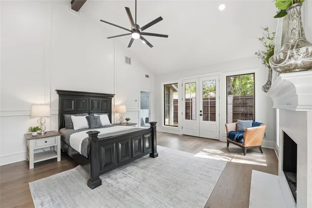 a spacious bedroom with a bed a couch and large window