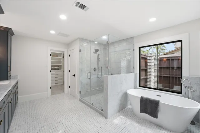 a spacious bathroom with a bathtub and a shower
