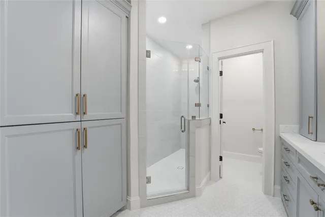 a bathroom with a shower and a glass door