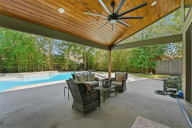 a view of patio with table and chairs under an umbrella