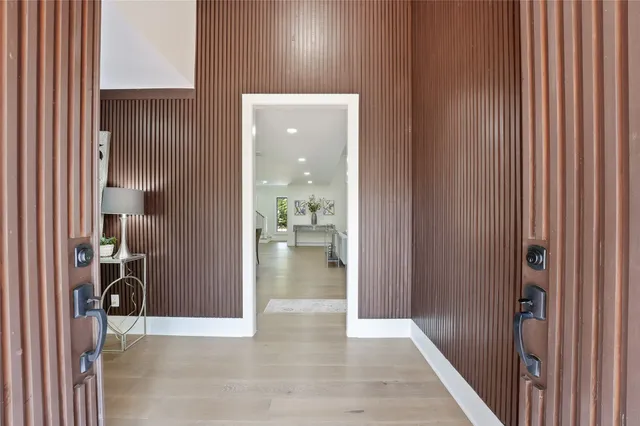 a view of a hallway with wooden shelves