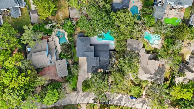 an aerial view of a house with a yard and garden space
