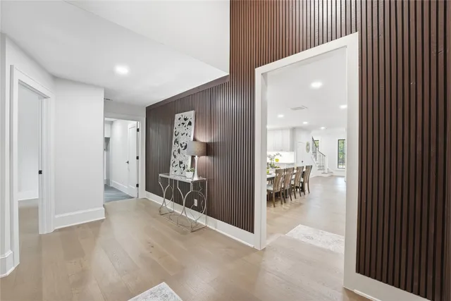a view of a hallway with dining room and furniture