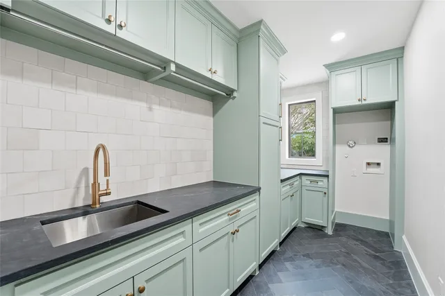 a kitchen with stainless steel appliances a sink and cabinets