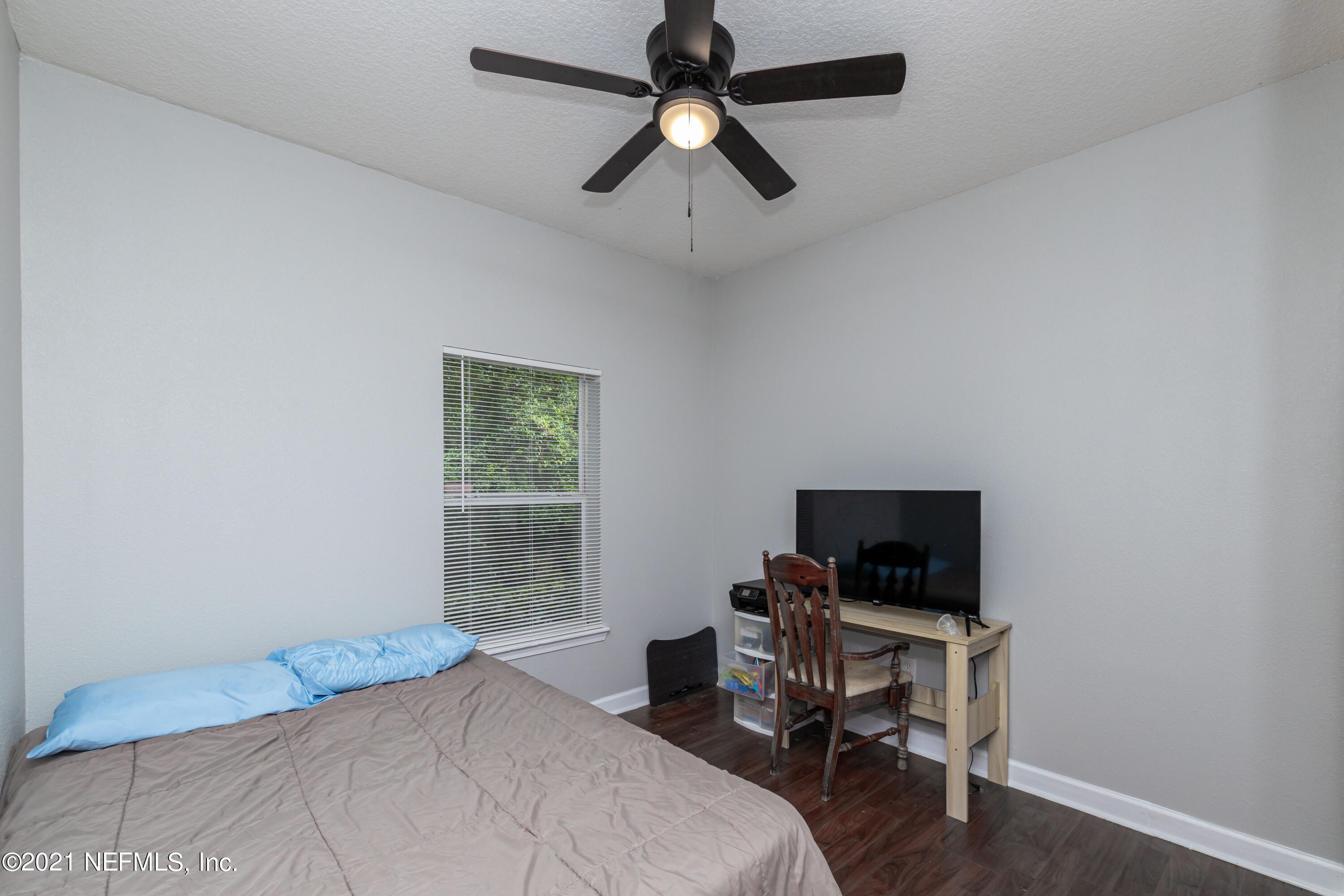 3670 Kirkpatrick Circle, Unit 2 Jacksonville, FL 32210 - Photo 12 of 17 a bedroom with a bed and a flat screen tv