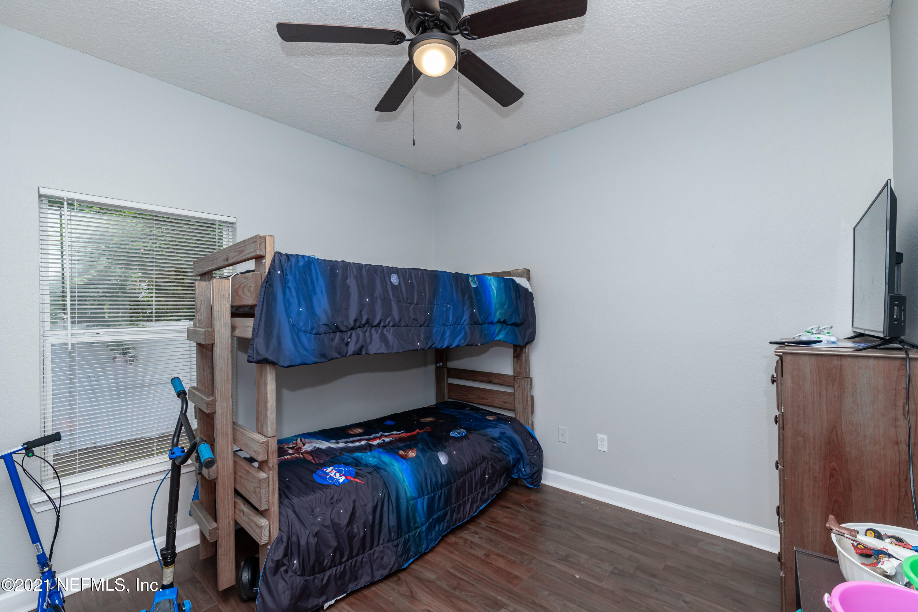 3670 Kirkpatrick Circle, Unit 2 Jacksonville, FL 32210 - Photo 14 of 17 a bedroom with a bed and wooden floor