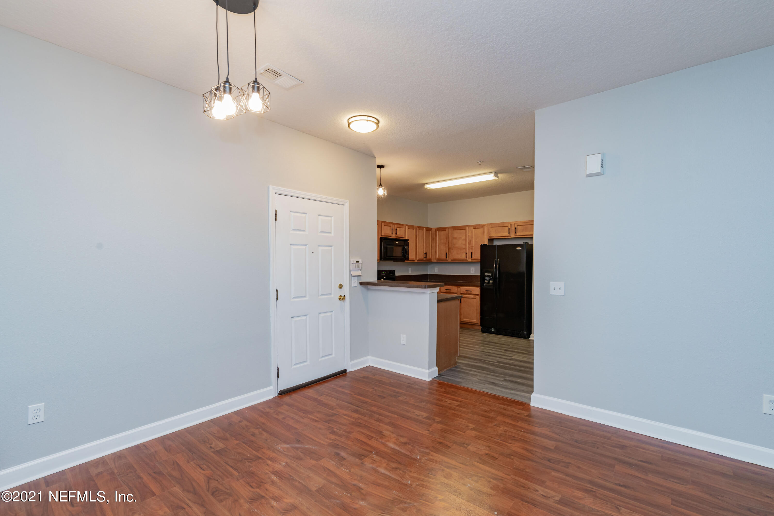 3670 Kirkpatrick Circle, Unit 2 Jacksonville, FL 32210 - Photo 2 of 17 a view of kitchen with granite countertop cabinets and refrigerator