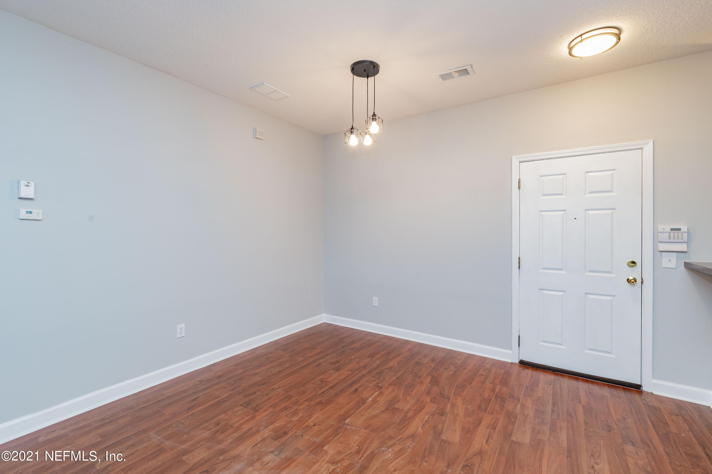 3670 Kirkpatrick Circle, Unit 2 Jacksonville, FL 32210 - Photo 3 of 17 wooden floor in an empty room with a window