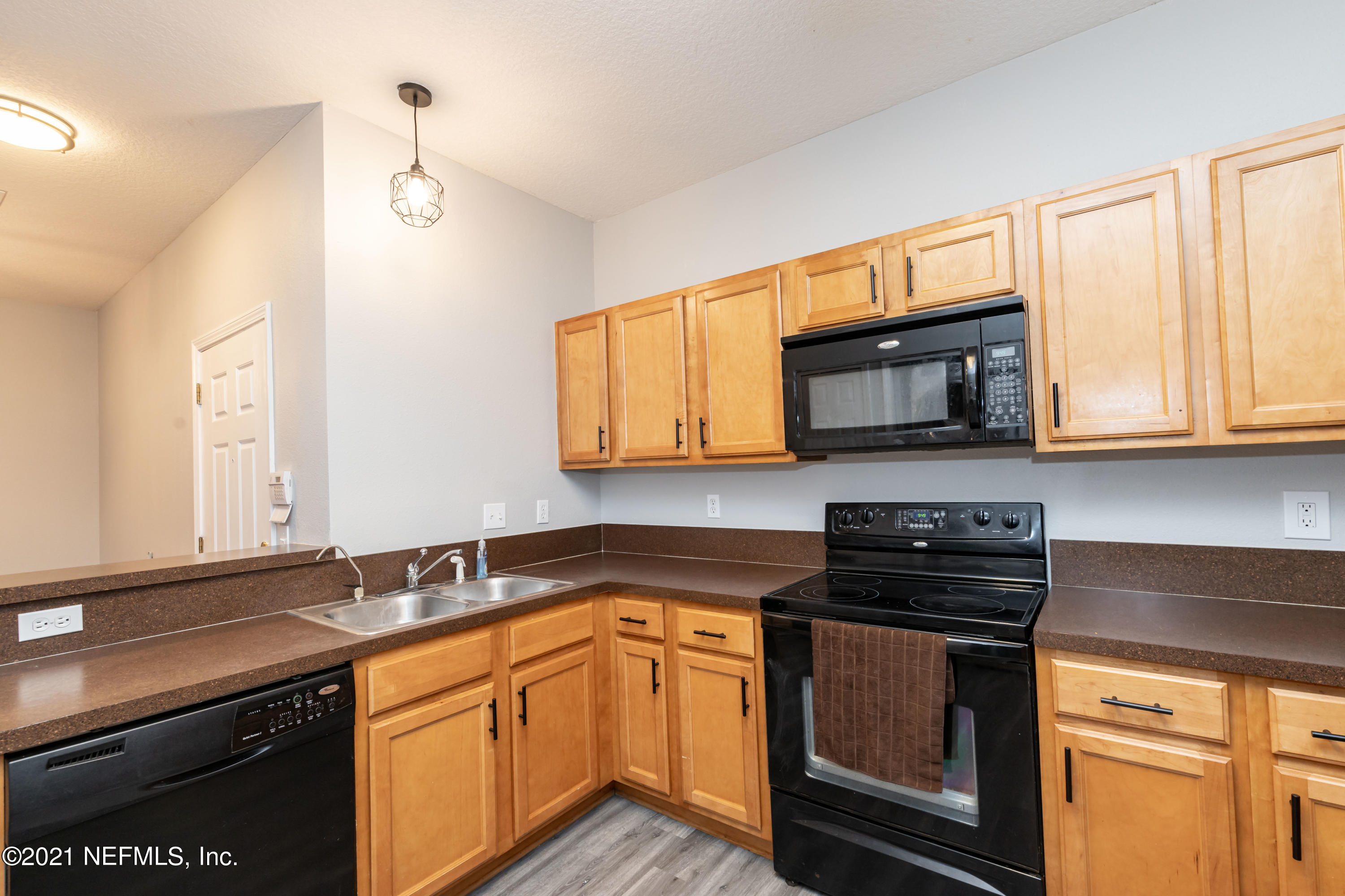 3670 Kirkpatrick Circle, Unit 2 Jacksonville, FL 32210 - Photo 5 of 17 a kitchen with stainless steel appliances granite countertop a sink stove and microwave