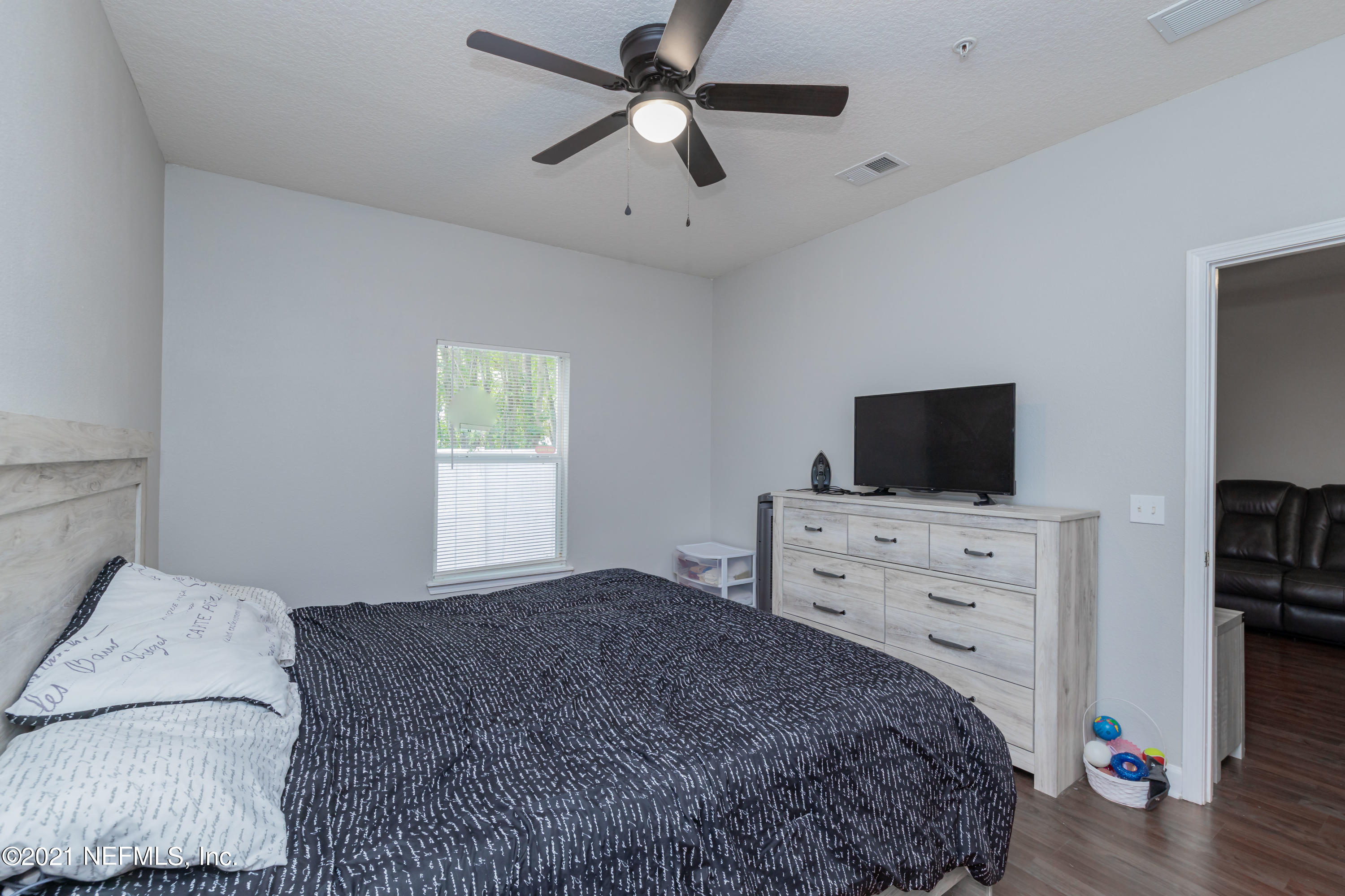 3670 Kirkpatrick Circle, Unit 2 Jacksonville, FL 32210 - Photo 10 of 17 a bedroom with a bed and flat screen tv