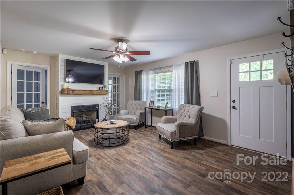 629 Blacksnake Road Stanley, NC 28164 - Photo 3 of 17 a living room with furniture a fireplace and a flat screen tv