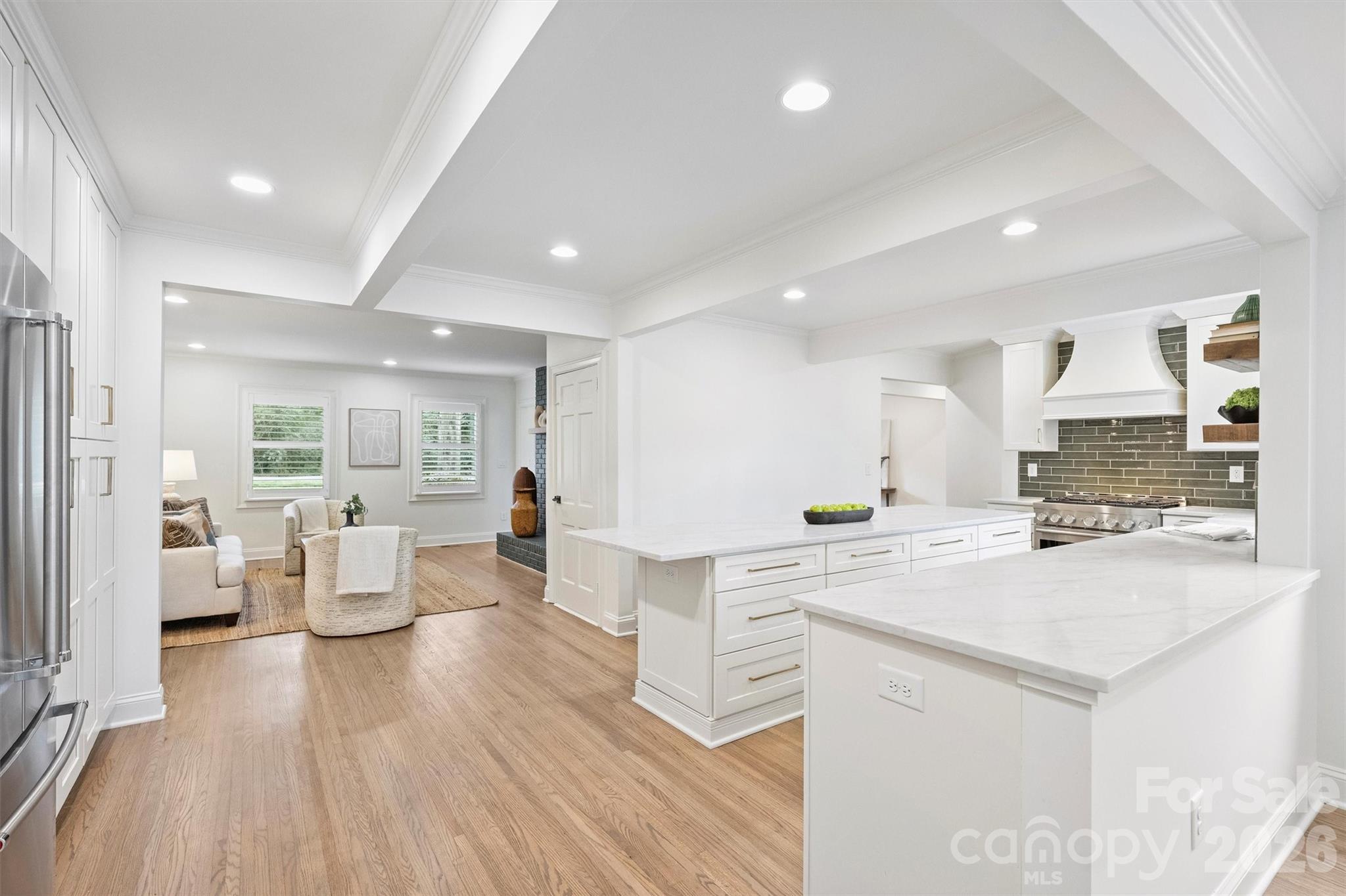 830 Jefferson Drive Charlotte, NC 28270 - Photo 11 of 44 a large white kitchen with lots of counter top space and living room