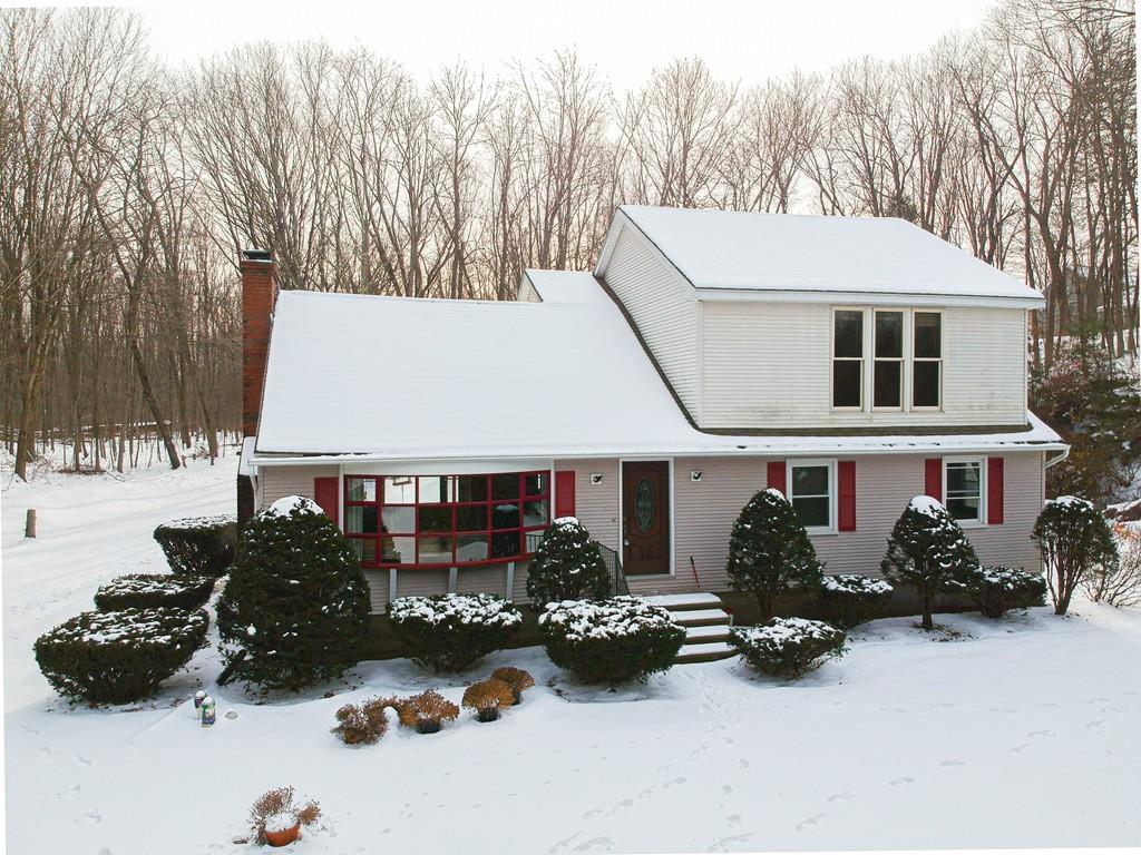 a view of a house with yard and sitting area