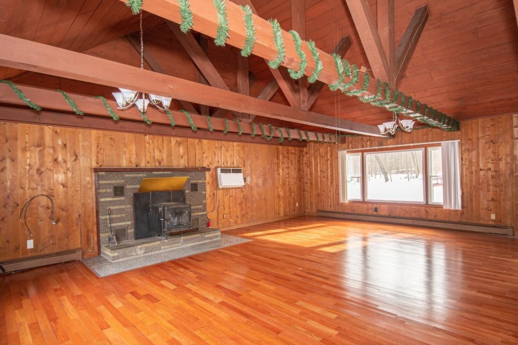 1103 Morgan Road West Springfield, MA 01089 - Photo 3 of 22 a view of an empty room with wooden floor fireplace and a window