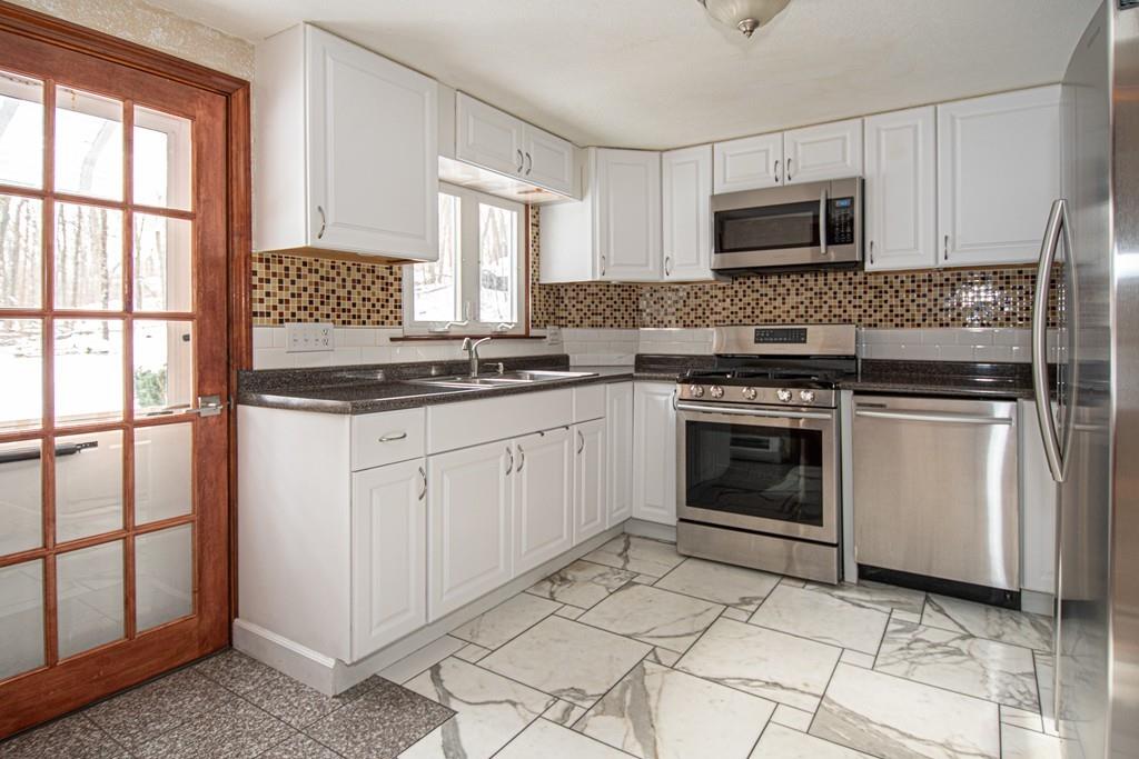 1103 Morgan Road West Springfield, MA 01089 - Photo 5 of 22 a kitchen with cabinets appliances and a window