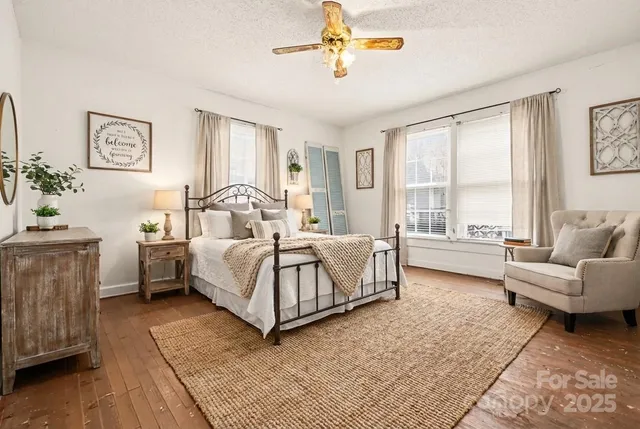 a bedroom with a bed couch and a window