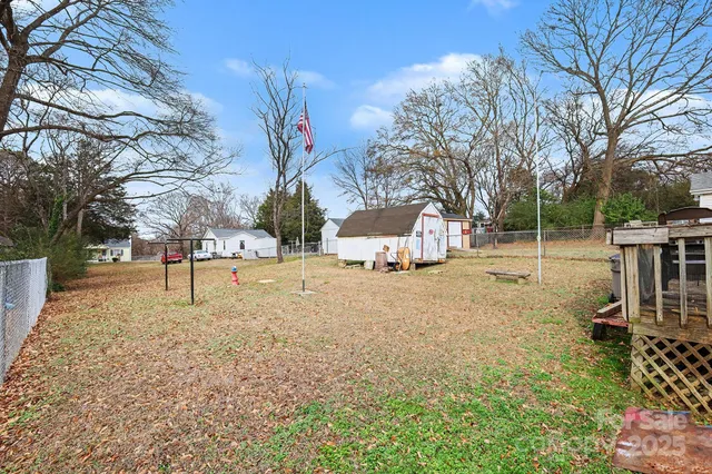 a view of a yard with a large tree and a yard