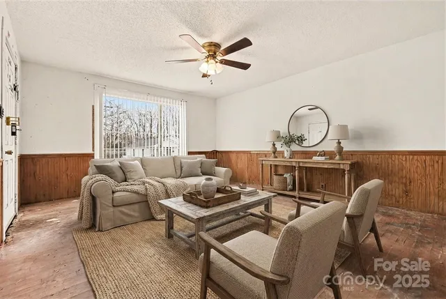 a living room with furniture a fireplace and a window