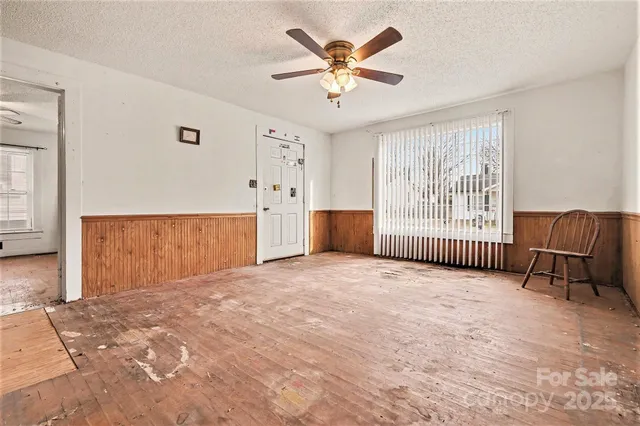 a view of livingroom with a ceiling fan and window