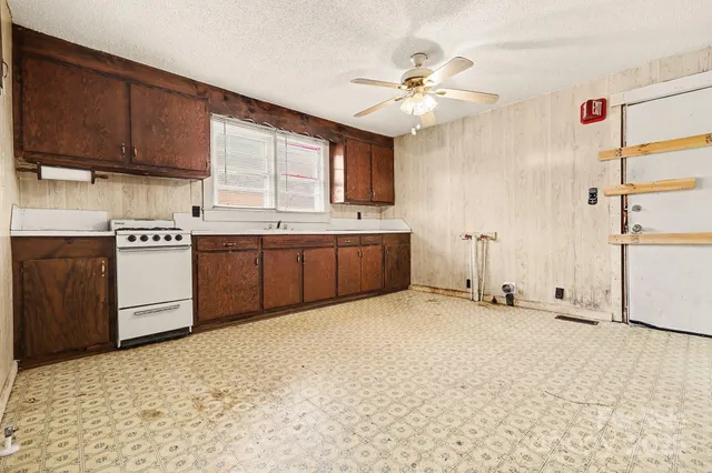 a kitchen with stainless steel appliances granite countertop a sink cabinets and window