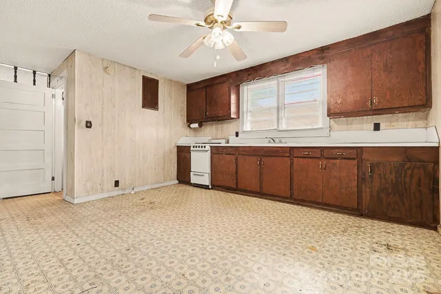 a kitchen with stainless steel appliances granite countertop a sink and a refrigerator