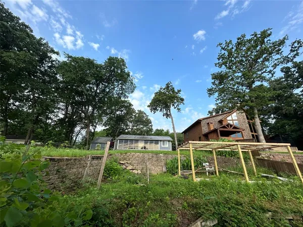 a white house with a yard and plants