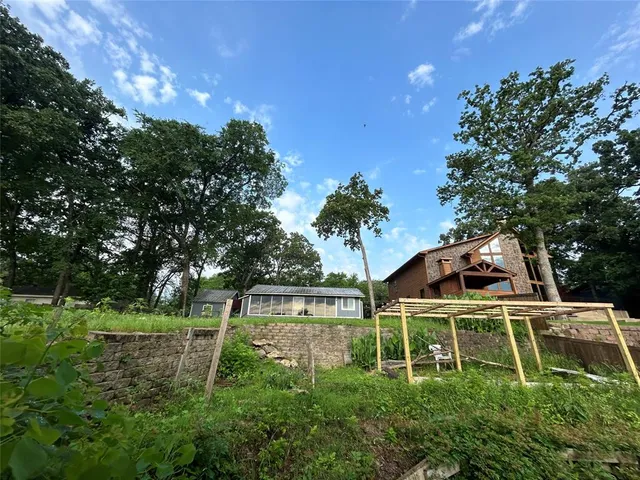 a white house with a yard and plants