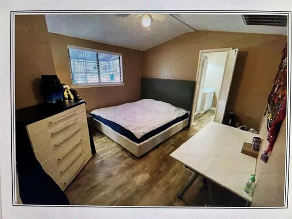 a bed room with a bed window and mirror