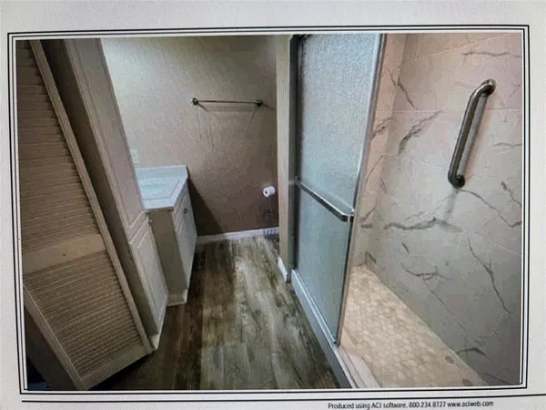 a view of closet with wooden floor and a carpet