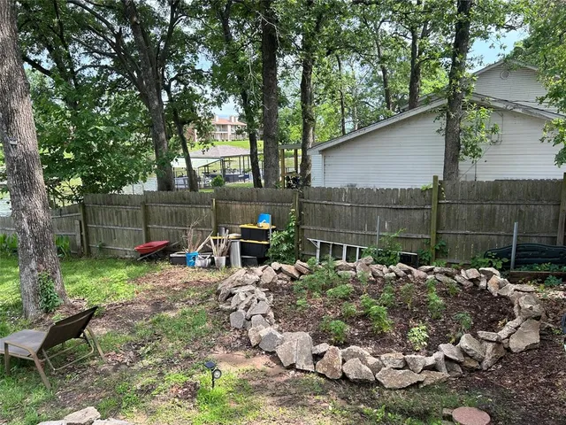 a view of a chair and table in backyard