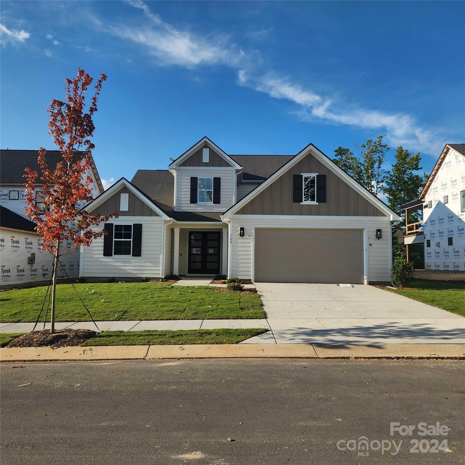 142 Windy Dell Drive Tega Cay, SC 29708 - Photo 1 of 20 a front view of a house with a yard and garage