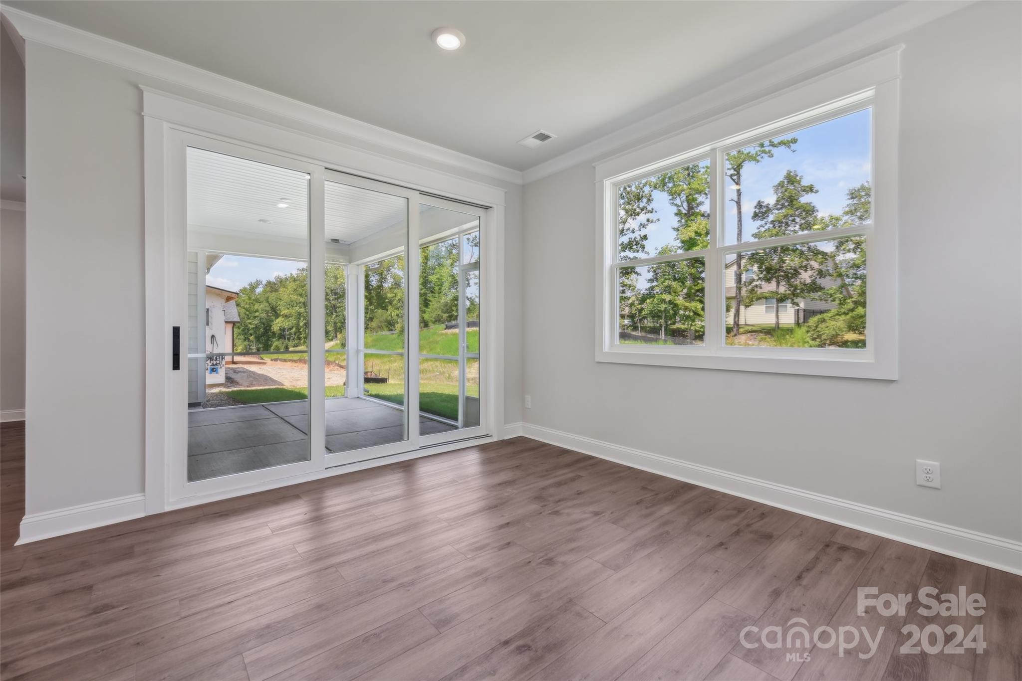 142 Windy Dell Drive Tega Cay, SC 29708 - Photo 11 of 20 a view of an empty room with wooden floor and a window