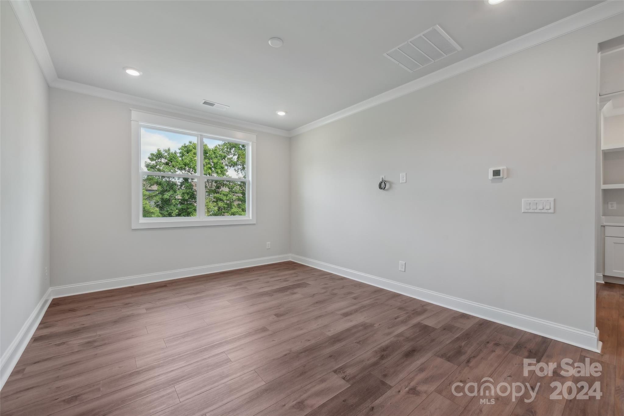 142 Windy Dell Drive Tega Cay, SC 29708 - Photo 16 of 20 a view of an empty room with wooden floor and a window