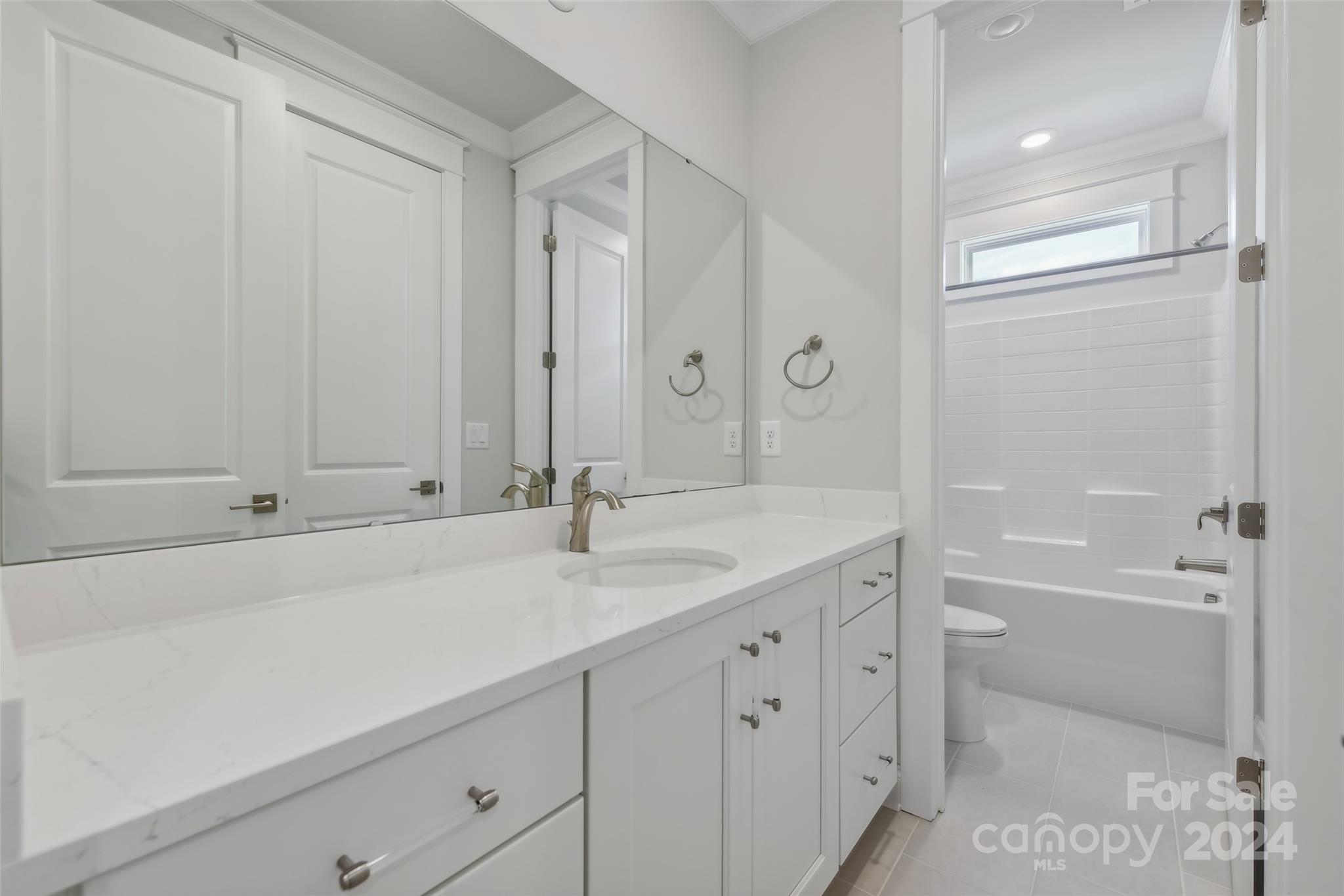142 Windy Dell Drive Tega Cay, SC 29708 - Photo 17 of 20 a bathroom with a sink and a mirror with bathtub