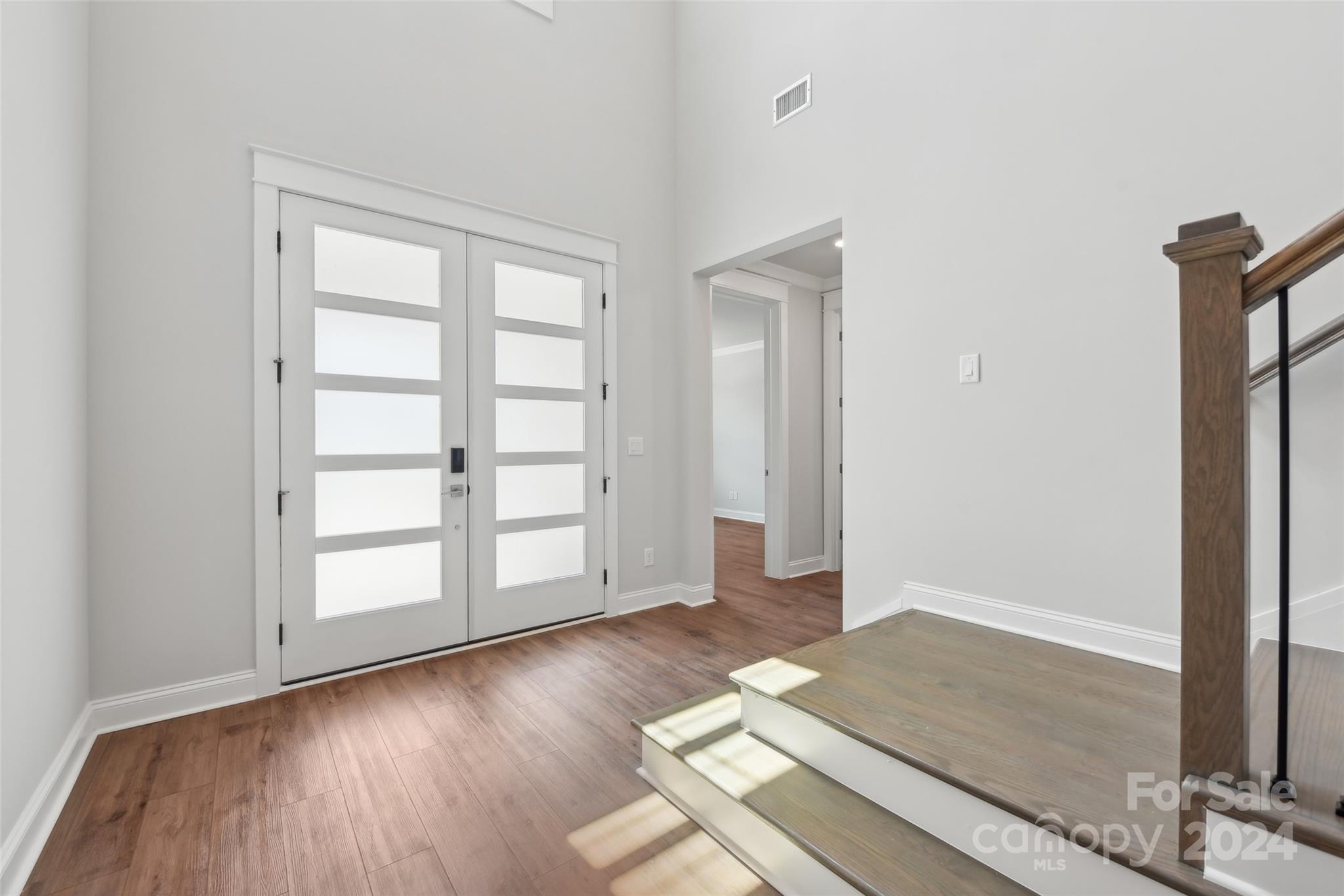 142 Windy Dell Drive Tega Cay, SC 29708 - Photo 2 of 20 an empty room with wooden floor and window