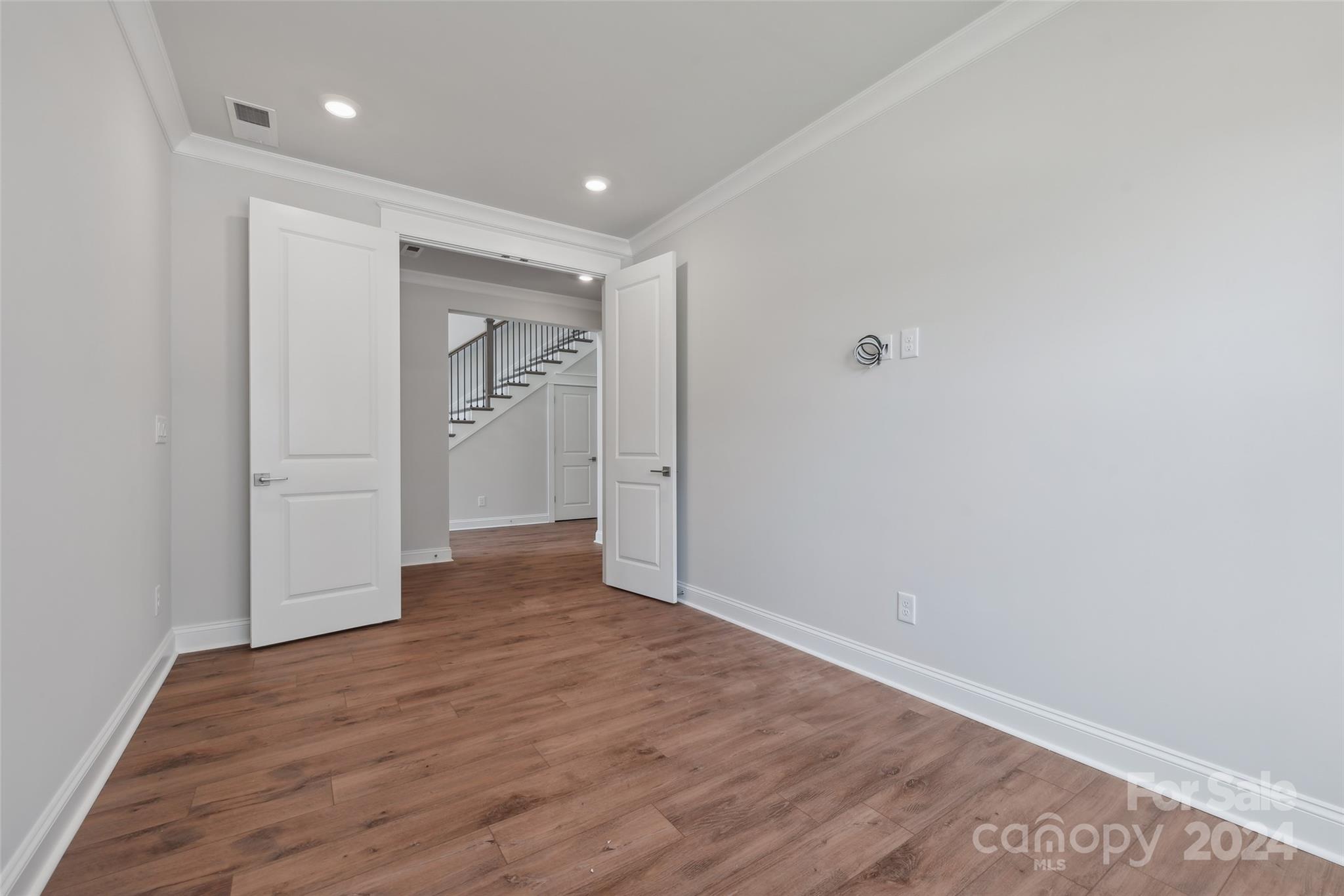 142 Windy Dell Drive Tega Cay, SC 29708 - Photo 5 of 20 a view of an empty room with wooden floor and closet