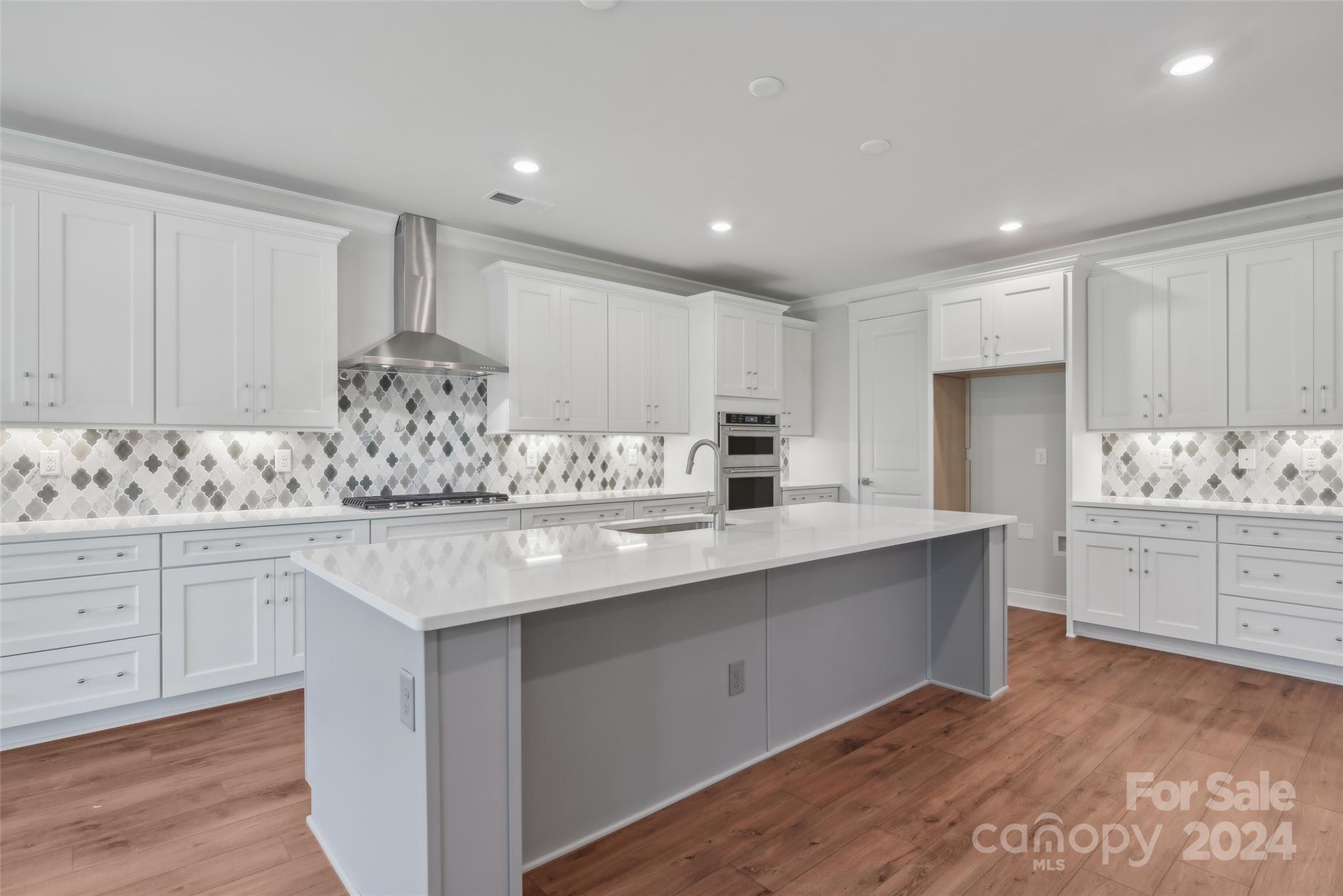 142 Windy Dell Drive Tega Cay, SC 29708 - Photo 6 of 20 a kitchen with granite countertop white cabinets and stainless steel appliances