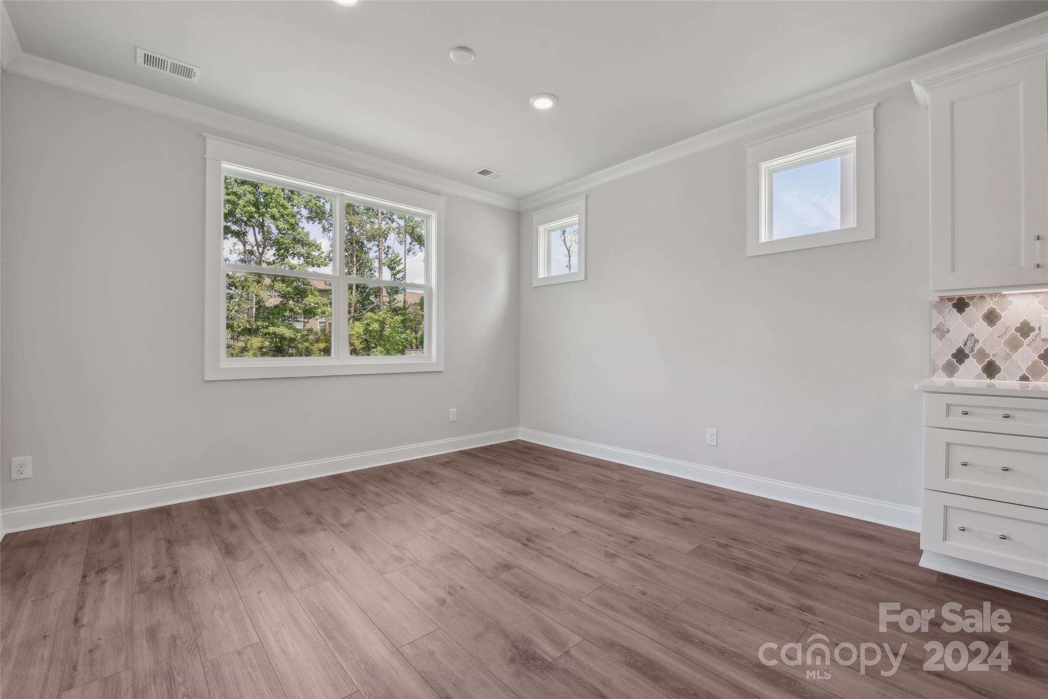 142 Windy Dell Drive Tega Cay, SC 29708 - Photo 10 of 20 a view of room with hardwood floor and window