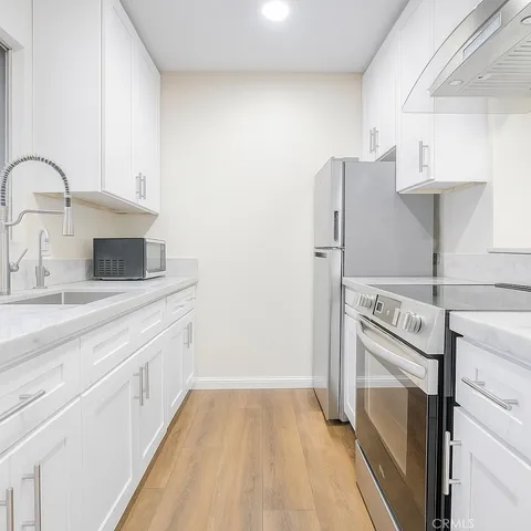 a kitchen with a refrigerator sink and stove