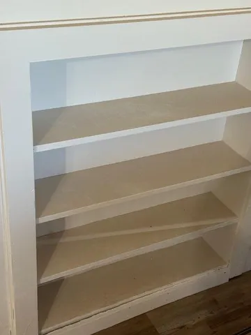 a view of a closet with wooden floor