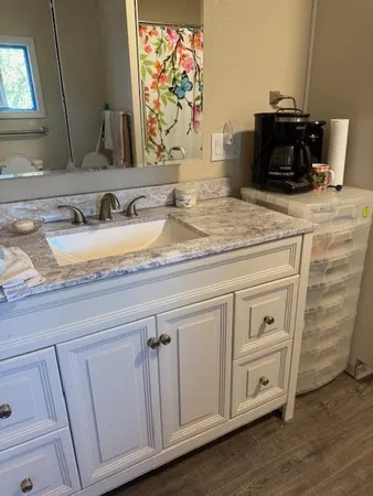 a bathroom with a sink and a mirror