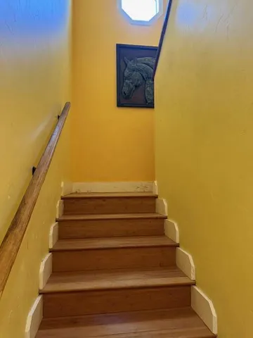 a bathroom with a granite countertop sink toilet and a mirror