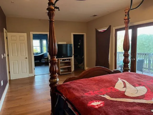 a bedroom with bed and a chandelier