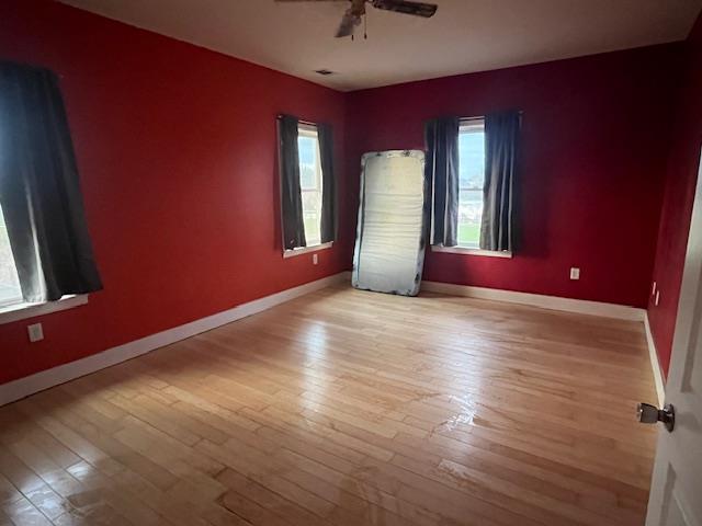 9537 Wamble Road Oakdale, CA 95361 - Photo 20 of 29 a view of empty room with window and wooden floor