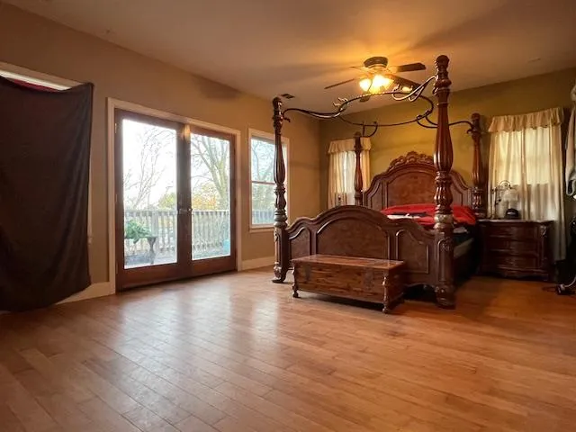 a bedroom with bed and a large window