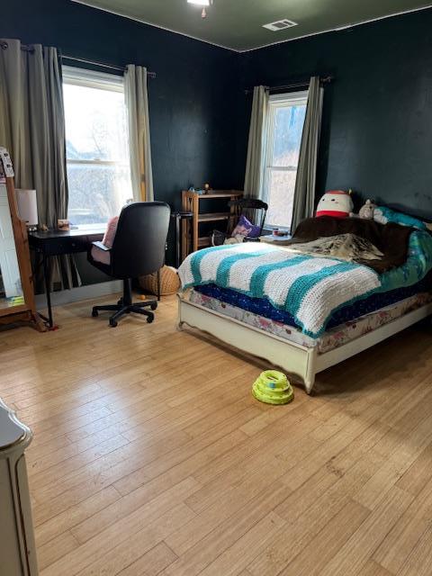 9537 Wamble Road Oakdale, CA 95361 - Photo 28 of 29 a bedroom with a bed a desk and chair with wooden floor