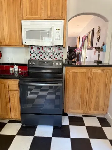 a room with stainless steel appliances and cabinets